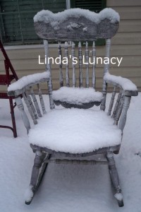 snow covered rocking chair